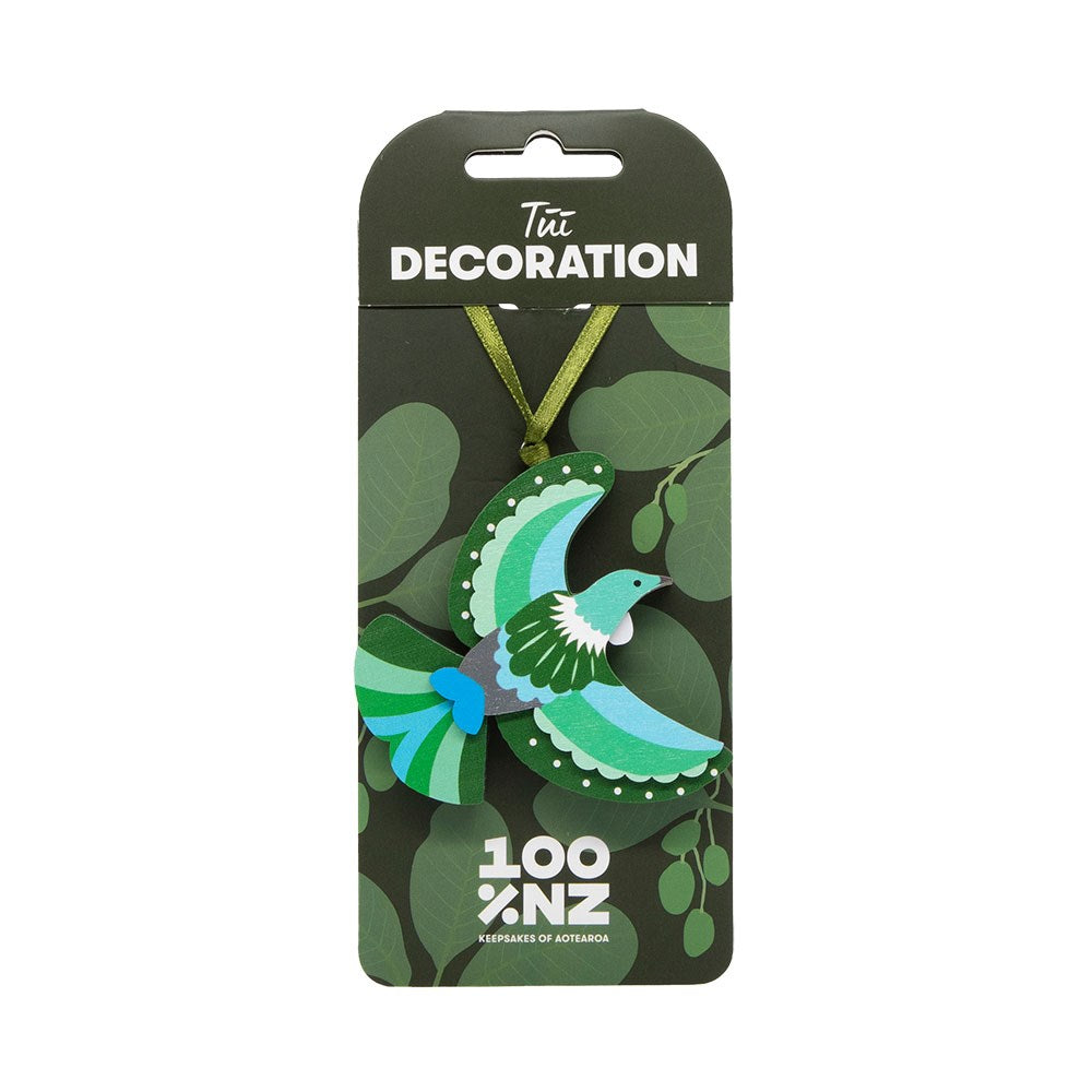 The Tui Wooden Decoration is a vibrant green, blue, and white bird-shaped ornament with a ribbon, ideal for a Kiwi Christmas tree. The bottom shows a 100% NZ logo and "Keepsakes of Aotearoa" text.