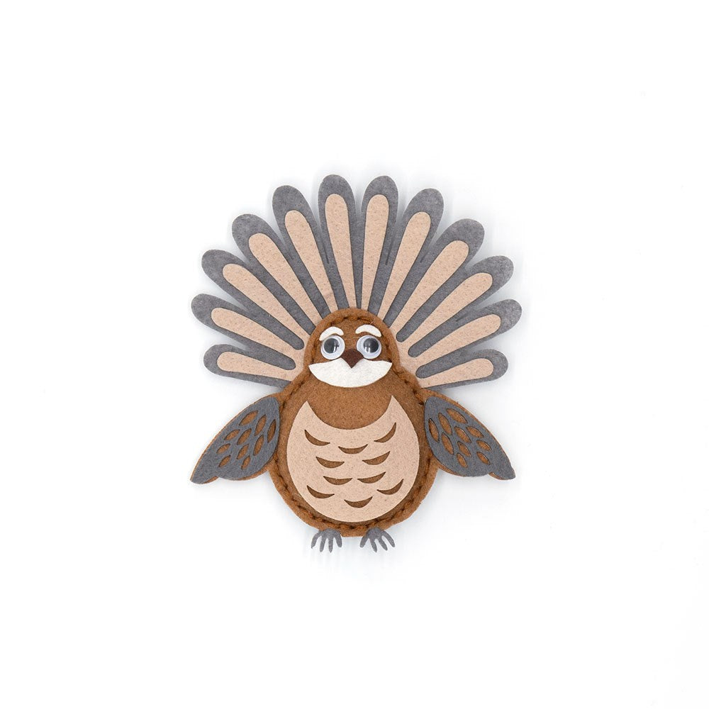 A flat, stylized paper turkey with a round brown body, wide eyes, and a fan-shaped tail highlights creative design—perfect inspiration for your next project with the Fantail Felt DIY Kit.