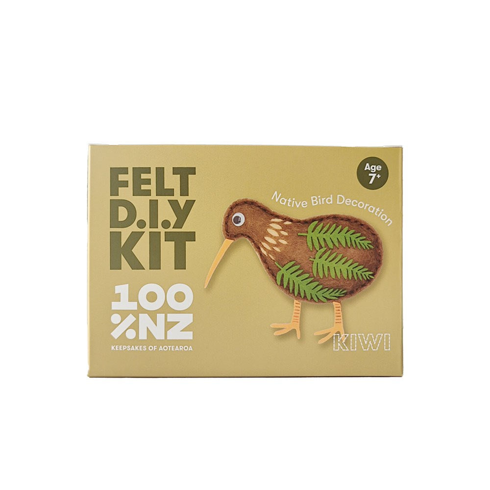 The Kiwi Felt DIY Kit comes in a tan box with a felt kiwi bird ornament featuring leaf patterns. Labeled Native Bird Decoration, Age 7+, 100% NZ, and Keepsakes of Aotearoa—ideal for creative, heartfelt gifts.