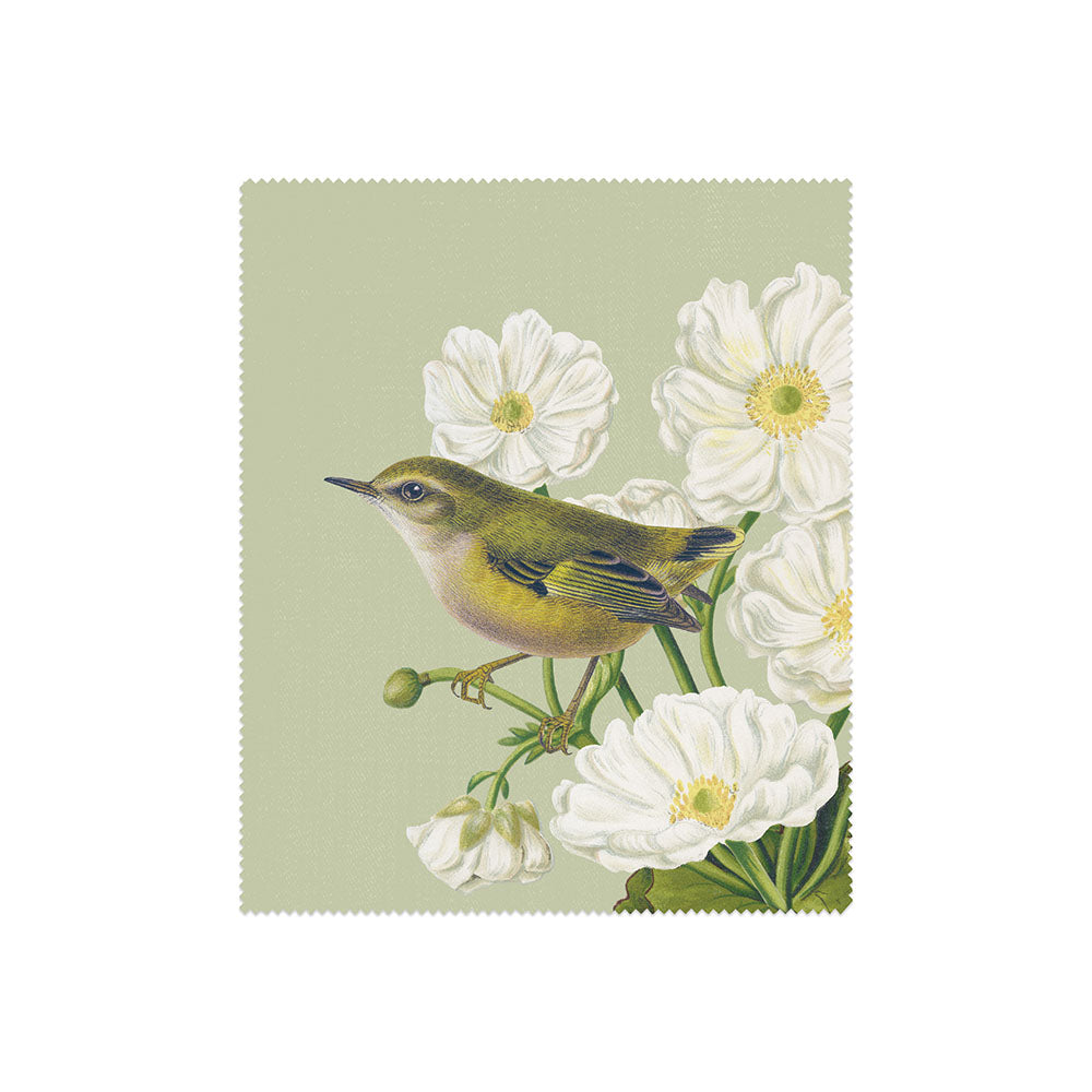 An illustration from the Set of 3 Birds & Botanicals Collection Lens Cloths features a small green and yellow bird perched among white botanicals and lush leaves on a pale green background.