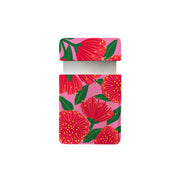 The Bright Botanical Pink Pohutukawa Pocket Mirror features a rectangular box with a partially open lid, showcasing a pink background and a vintage botanicals pattern of bold red flowers with yellow centers and green leaves.