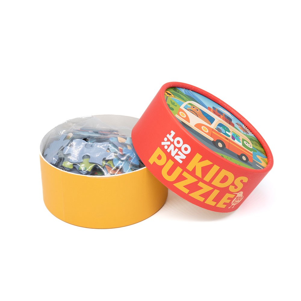Round yellow and red box labeled Kiwi Road Trip Kids Puzzle with a car illustration on the lid. The open box shows jigsaw puzzle pieces, partially covered in clear plastic—perfect for a fun adventure across New Zealand.