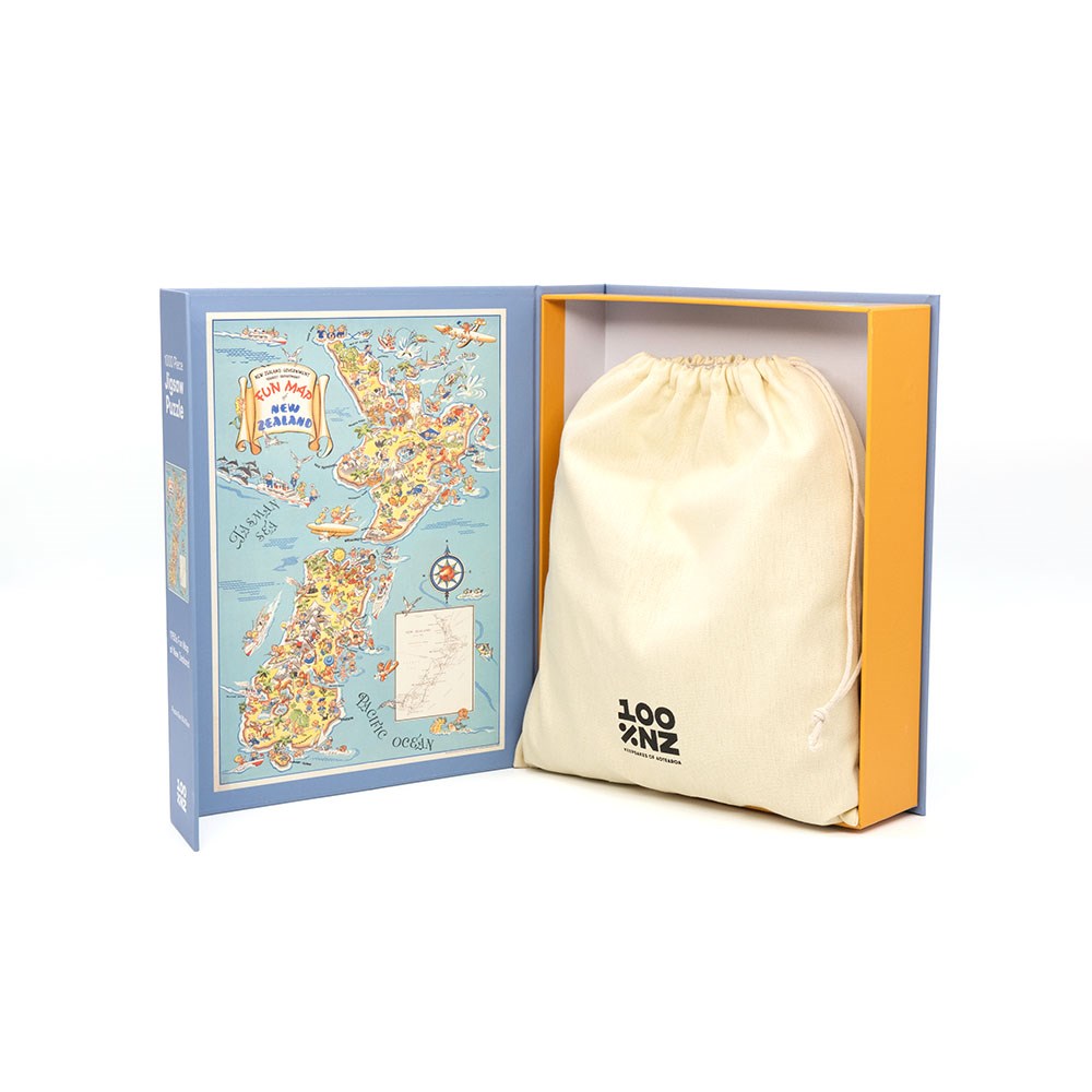 An open 1950s Fun Map Jigsaw Puzzle box shows a colorful illustrated Great Britain map on the left, and a cream drawstring bag with a black logo on the right, all set against a white background evoking vintage puzzle displays.