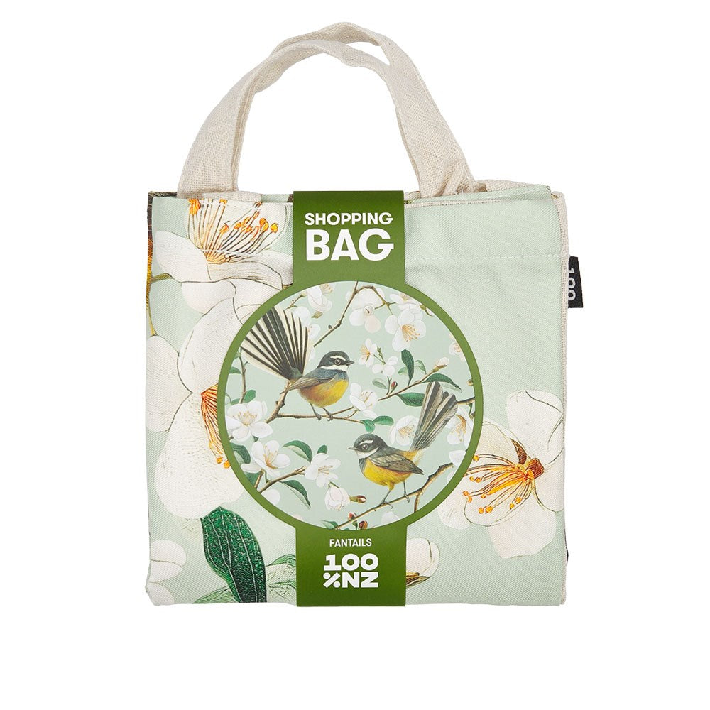 The Chatty Fantails Shopping Bag has beige handles, a floral print with two birds on branches, and a green label reading Shopping Bag. Above the round illustration is FANTAIS, and below is LOOK NZ—affordable style for everyone.