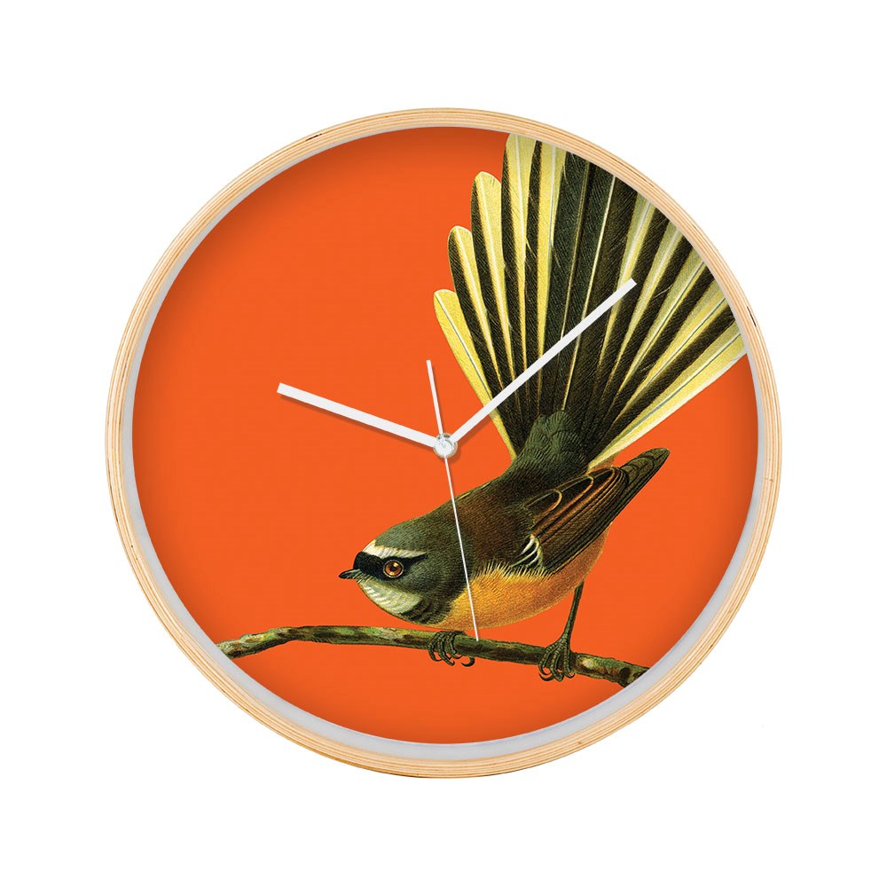 The Bright Fantail Wooden Frame Clock features a bright Fantail bird perched on a branch against an orange background. It has silent movement for quiet timekeeping and is finished with white hour, minute, and second hands.