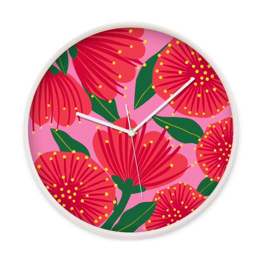 The Bright Botanical Pink Pohutukawa Wooden Frame Clock features a vibrant pink floral background inspired by New Zealand blooms, a wooden frame, silent movement, and white hands—perfect for adding charm to any space.