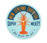 The NZ Seafood Crayfish Frameless Clock showcases a crayfish illustration with “NEW ZEALAND CRAYFISH SUPER MEATY Hot from the pot” text. Its light blue design includes silent movement and white hands.