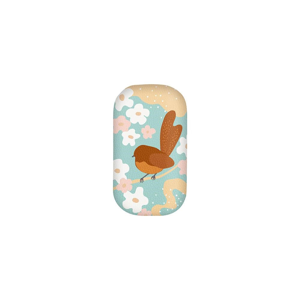 The Cut-out Fantail Trinket Box is a rectangular travel case with rounded edges, featuring a brown bird amid white and pink flowers on a light blue and beige patterned background—perfect for travellers.