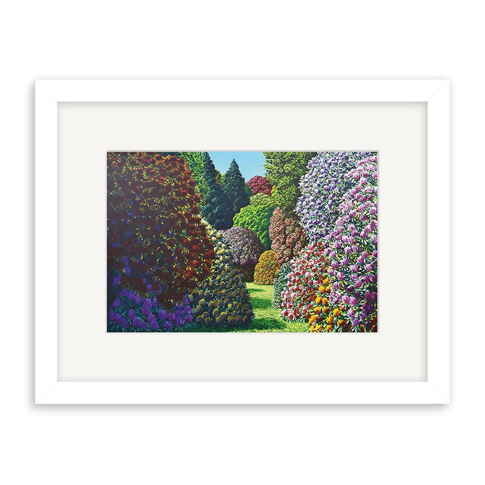 The Karl Maughan - Forest Hill Small Art Print: Second Frame features a vibrant garden scene with colorful trees and bushes in purple, red, orange, and green. Sunlight graces the central grass. The print is presented in a white frame with a wide mat.