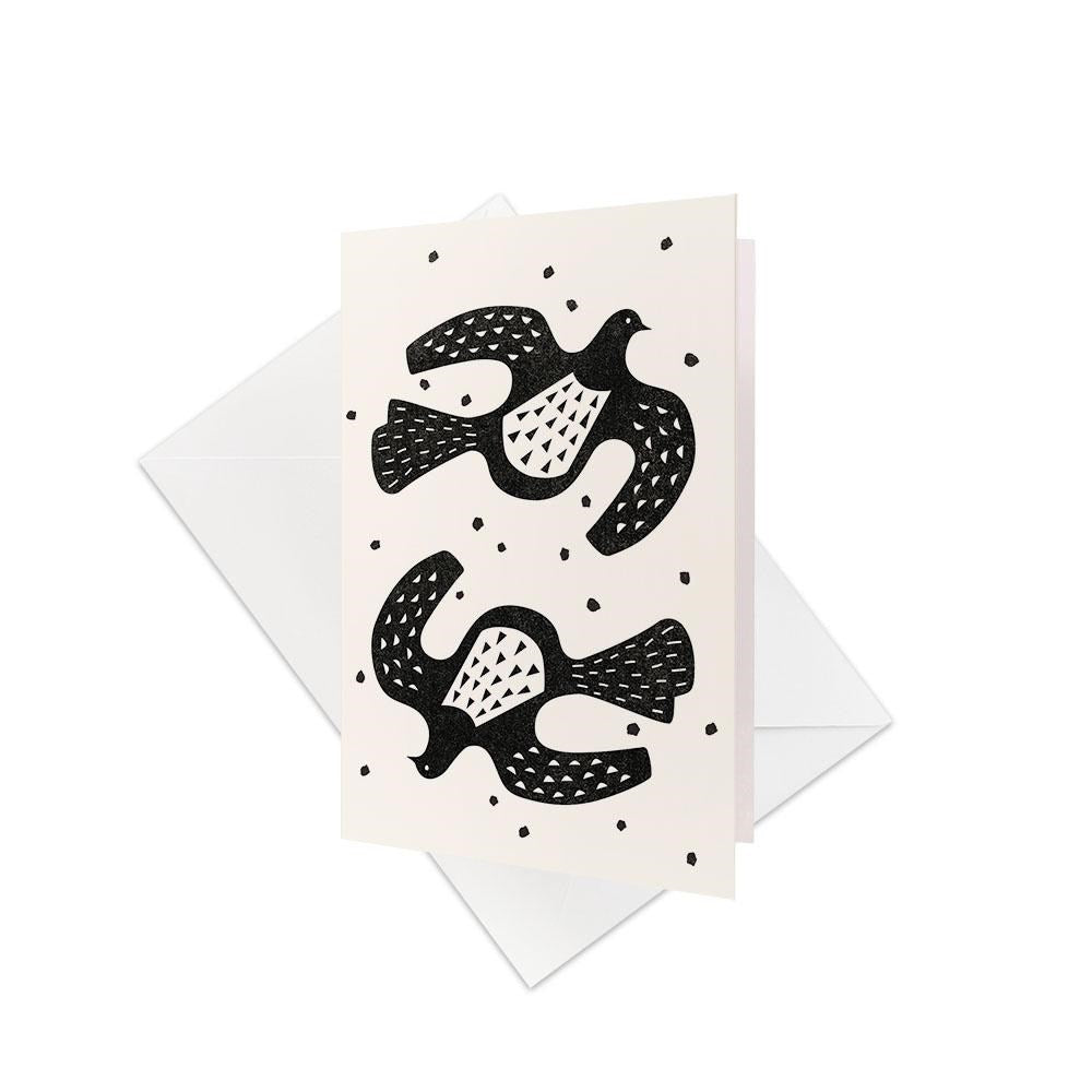 The Linocut Kereru Gift Card & Envelope (6 Pack) features minimalist black and white cards with two stylized birds and dot accents—ideal as blank occasion cards or unique New Zealand gift cards.
