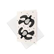 The Linocut Kereru Gift Card & Envelope (6 Pack) features minimalist black and white cards with two stylized birds and dot accents—ideal as blank occasion cards or unique New Zealand gift cards.