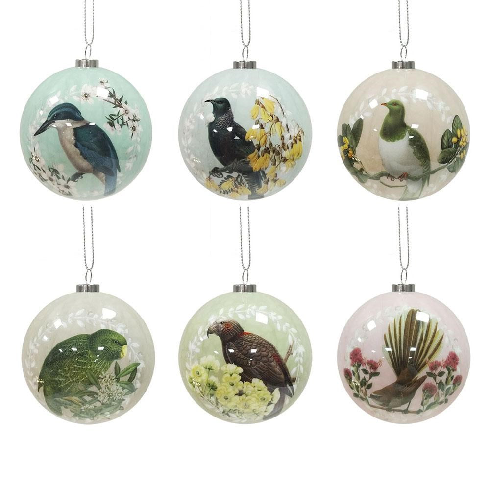 The Box of Six Native Bird Christmas Baubles - Second features round ornaments, each with a unique New Zealand native bird design, bringing a traditional Kiwi touch to your tree. Silver strings make them easy to hang against a white background.