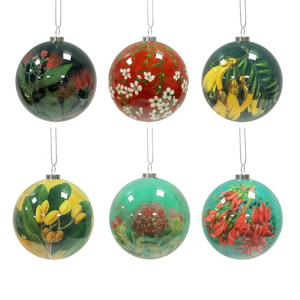 The Box of Six Flora Christmas Baubles - Second features glossy glass baubles adorned with New Zealand Native Flora in red, green, and yellow, beautifully arranged in two rows of three with unique festive botanical designs.