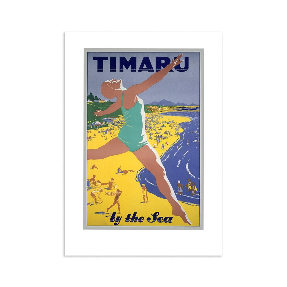 The Timaru Tourist Print showcases a vintage scene of a woman in a swimsuit leaping on a yellow beach, surrounded by sunbathers and swimmers, with TIMARU by the Sea set against scenic mountains and sea.