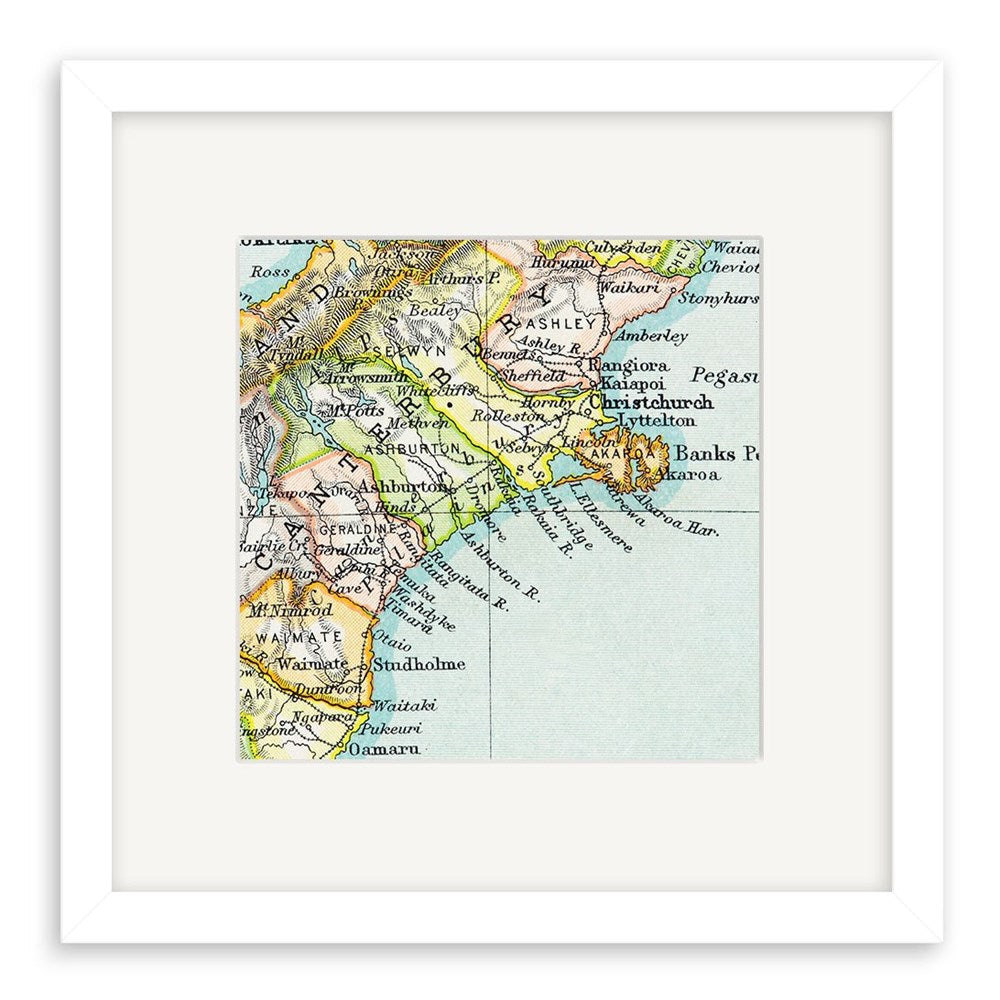 The Canterbury Vintage Map Print - Second is a framed giclee print of New Zealand’s Otago and Canterbury regions in muted 19th-century lithograph style, highlighting towns and coasts, all set within a white mat and frame.