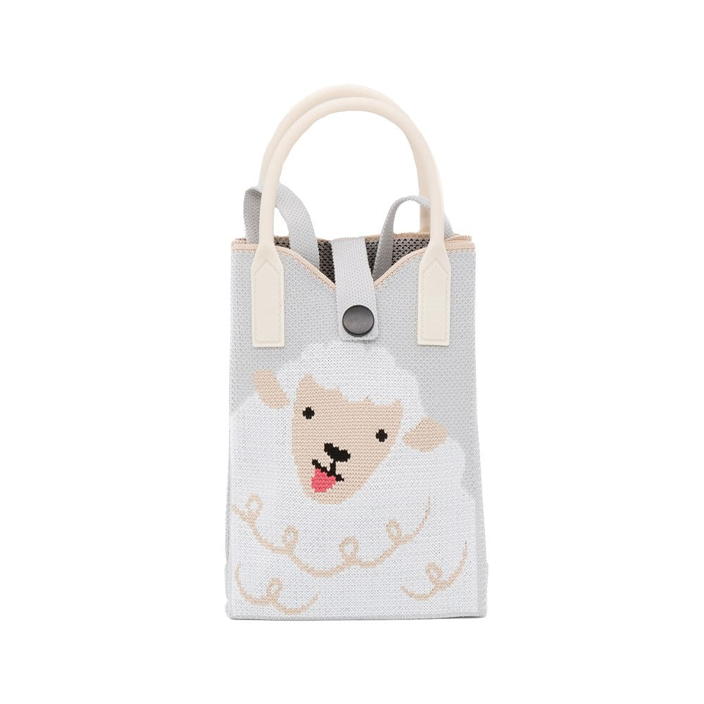 The Sheep Cross-body Bag is a small, lightweight gray mini bag with cream handles, featuring woven sheep artwork—a smiling sheep with white wool and a beige face. It is secured at the top with a black snap button.