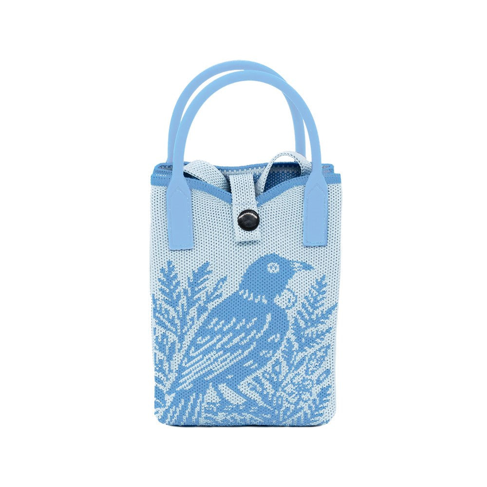 The Tui Woodcut Cross-body Bag is a lightweight mini tote in light blue, featuring native bird art in dark blue, two handles, and a convenient top button closure.
