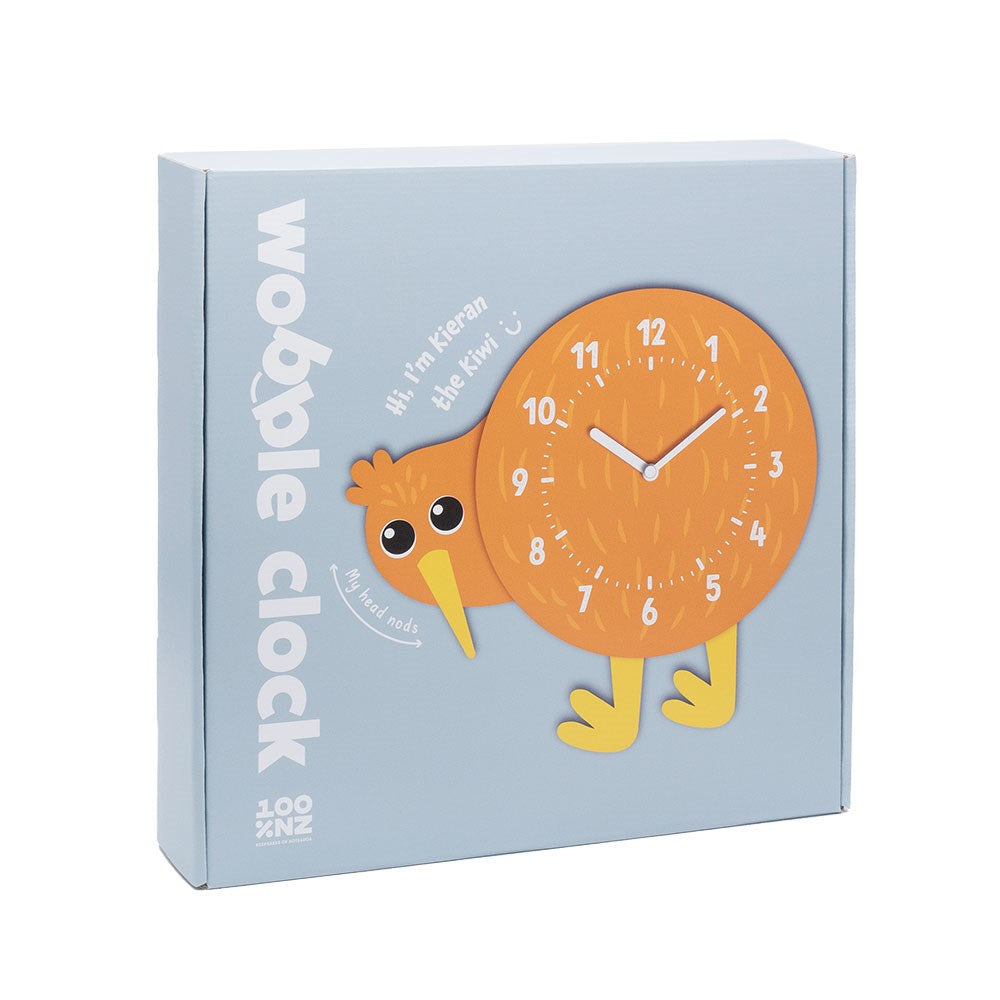 The Kiwi Kids Wobble Clock comes in a blue box with a New Zealand-inspired design, shaped like an orange kiwi bird. The text says "wobble clock" and "Hi! I'm Kieran the Kiwi," highlighting its bobbing head clock face.