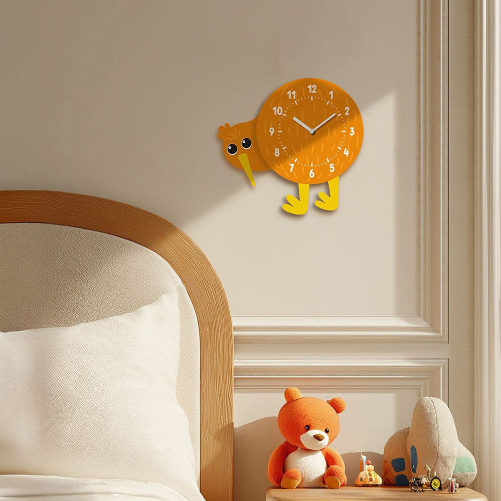 A Kiwi Kids Wobble Clock with a yellow bobbing head hangs on a cream wall above a wooden bed with white bedding. On the bedside table, an orange teddy bear and whale toy add to the playful New Zealand-inspired decor.