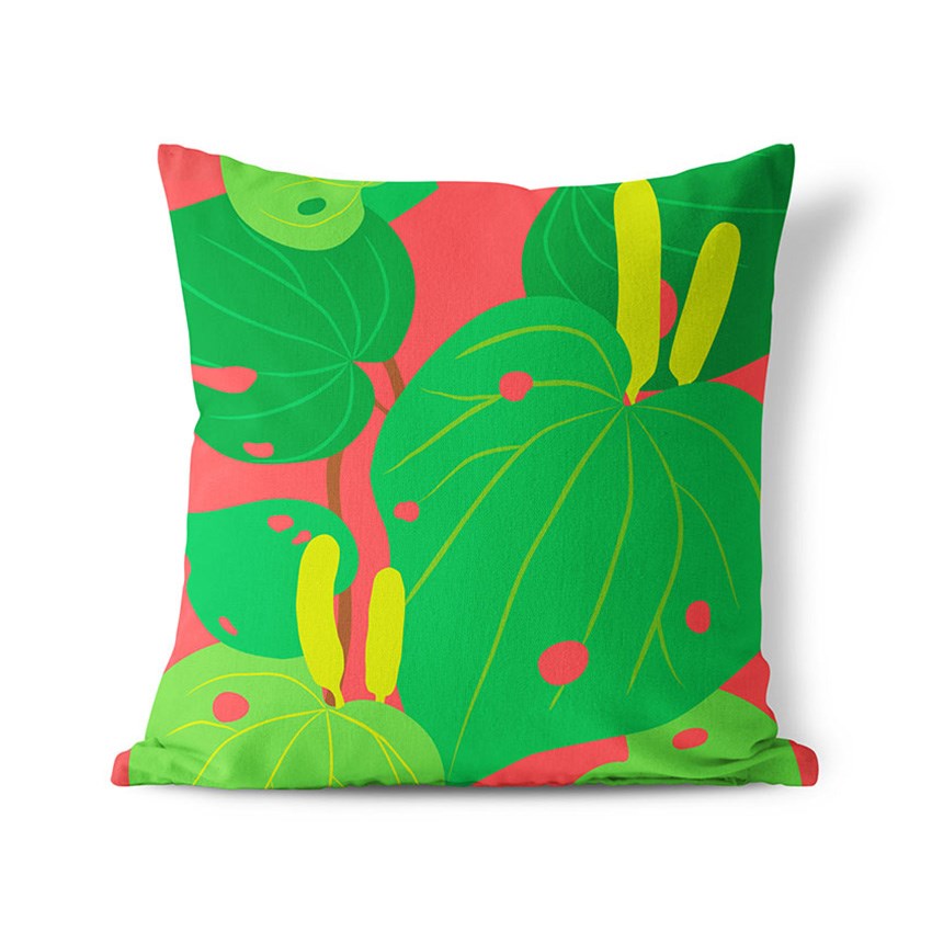 The Bright Botanical Kawakawa Cushion Cover features a bold, modern print of large green leaves with yellow stems and red dots on a coral pink background. This square, polyester cover is perfect for adding tropical style to any indoor or outdoor space.