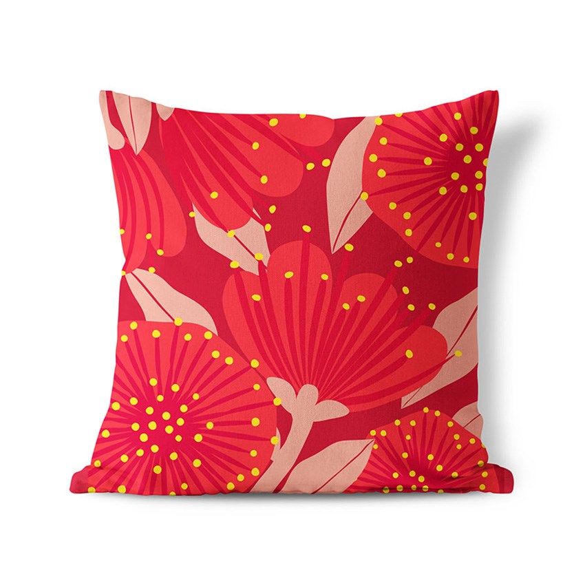 The Bright Botanical Red Pohutukawa Cushion Cover is a square polyester cover with a bold floral pattern of large red and pink flowers, yellow dots, and a red background. This modern NZ design suits indoor or outdoor use, shown on a white backdrop.