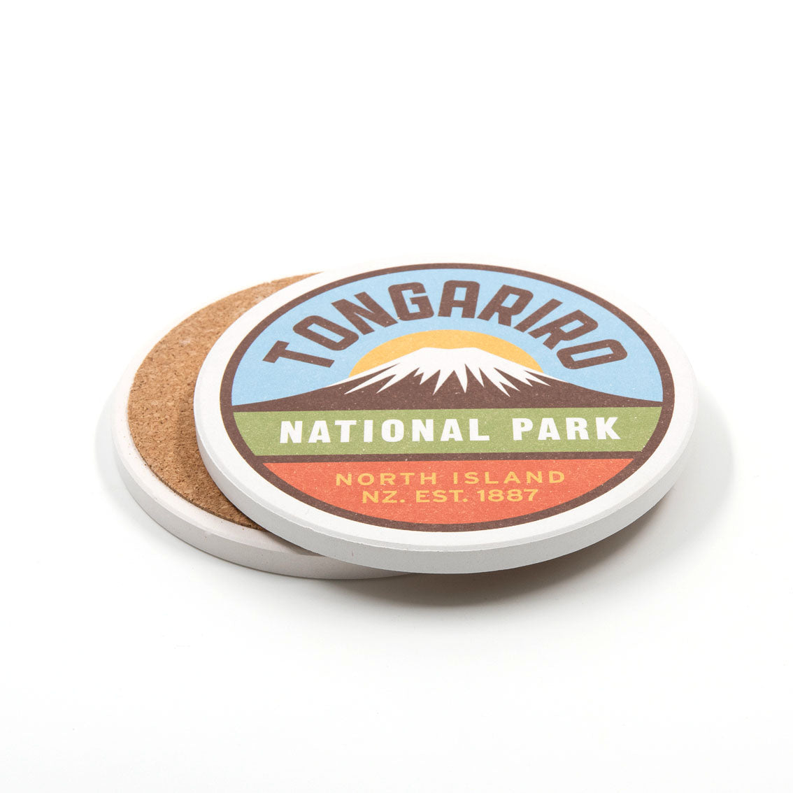 The Set of 4 National Park Coasters includes a Glenn Jones-designed Tongariro National Park coaster with mountain art and "Est. 1887" text on top, and a brown cork backing visible underneath.