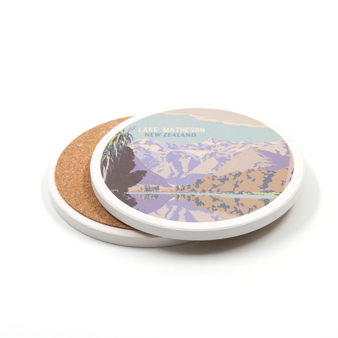 The Set of 4 Tourist Ceramic Coasters is shown; one coaster displays a vintage Lake Matheson, New Zealand landscape, while another reveals its cork backing. Both are set against a white background.