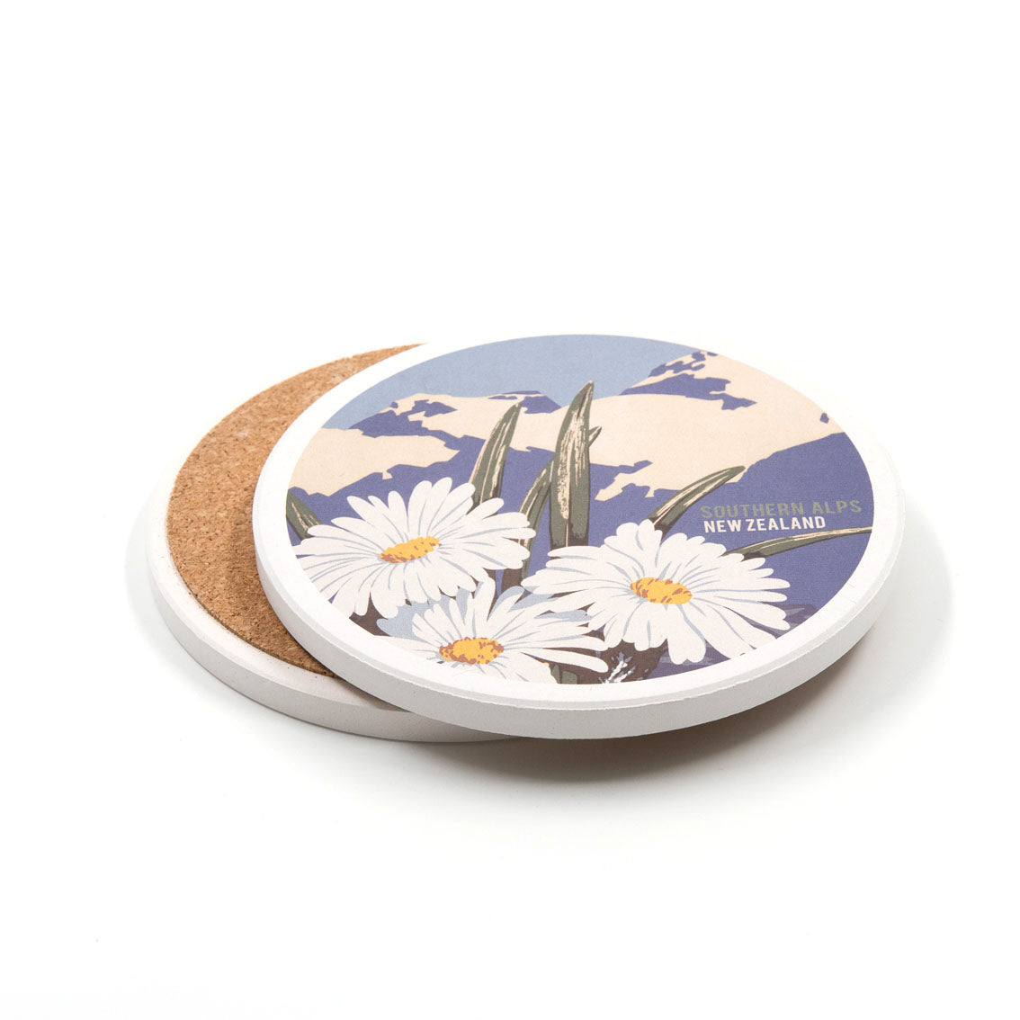 Set of 4 Tourist Ceramic Coasters shown: one with a vintage print of white daisies, foliage, mountains, and "Southern Alps New Zealand" label; another displays the cork backing. Both feature white edges.