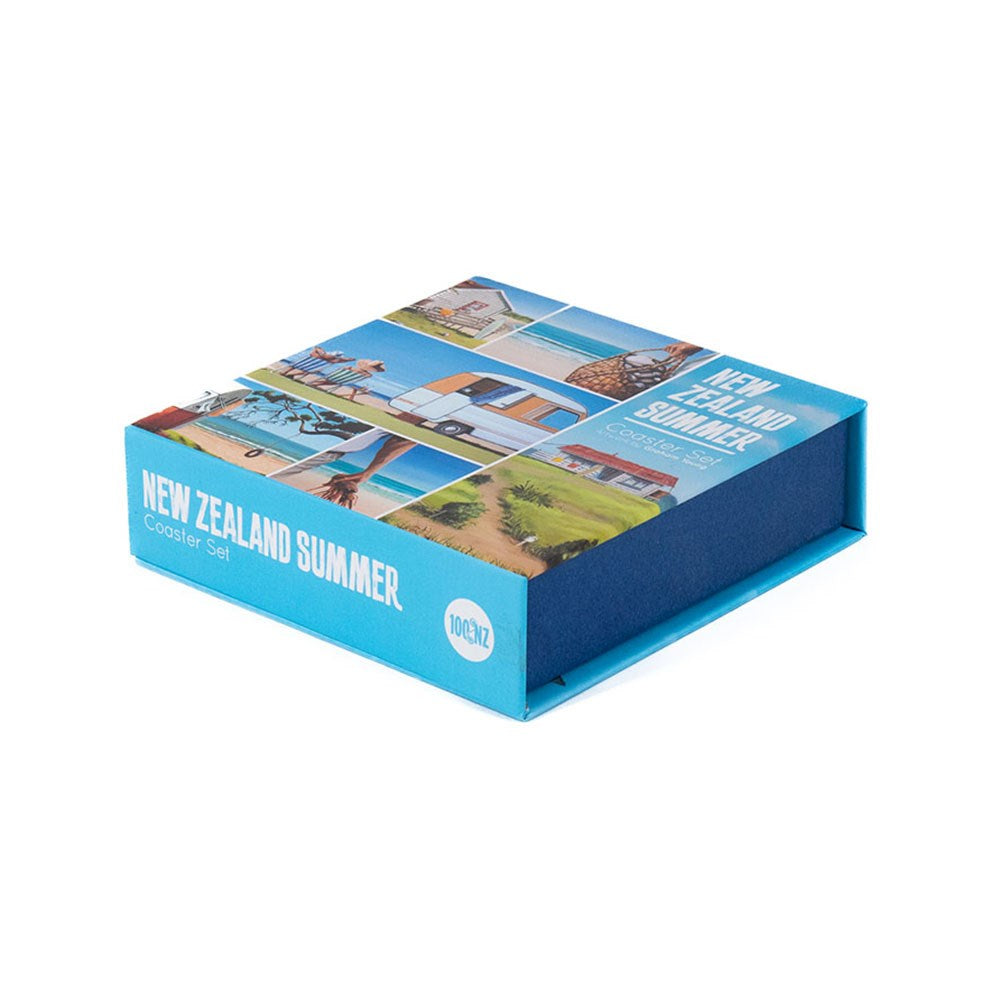 A square blue box labeled Graham Young NZ Summer Set of 6 Coasters, ideal for beach lovers, shows summer scenes like a beach, house, and palm trees on the lid. The unopened set is pictured from a slight angle.