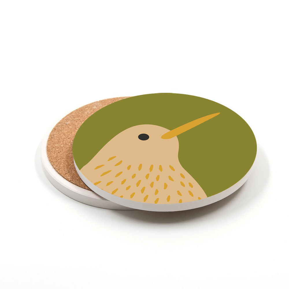 This Set of 4 Storybook Ceramic Coasters features round ceramic coasters with cork backing, each displaying a stylized kiwi bird—yellow beak, light brown feathers with dark spots—on a green background, inspired by New Zealand.