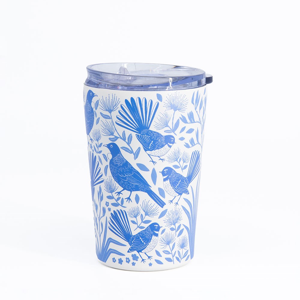 The Birdsong Blues Coffee Cup is a reusable travel cup with a clear, spill-proof lid, showcasing a blue and white birds-and-flowers design on its exterior, set against a plain white background.