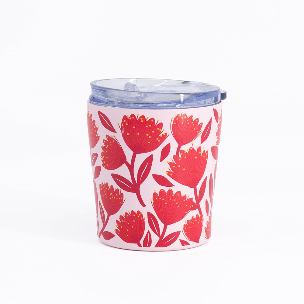 Introducing the Pohutukawa Glade Coffee Cup, a white tumbler with a clear plastic lid adorned in a vibrant pattern of red pohutukawa flowers and lush green leaves. This vacuum insulated coffee cup is displayed against a plain white background, seamlessly uniting style and function to elevate your favorite beverages.