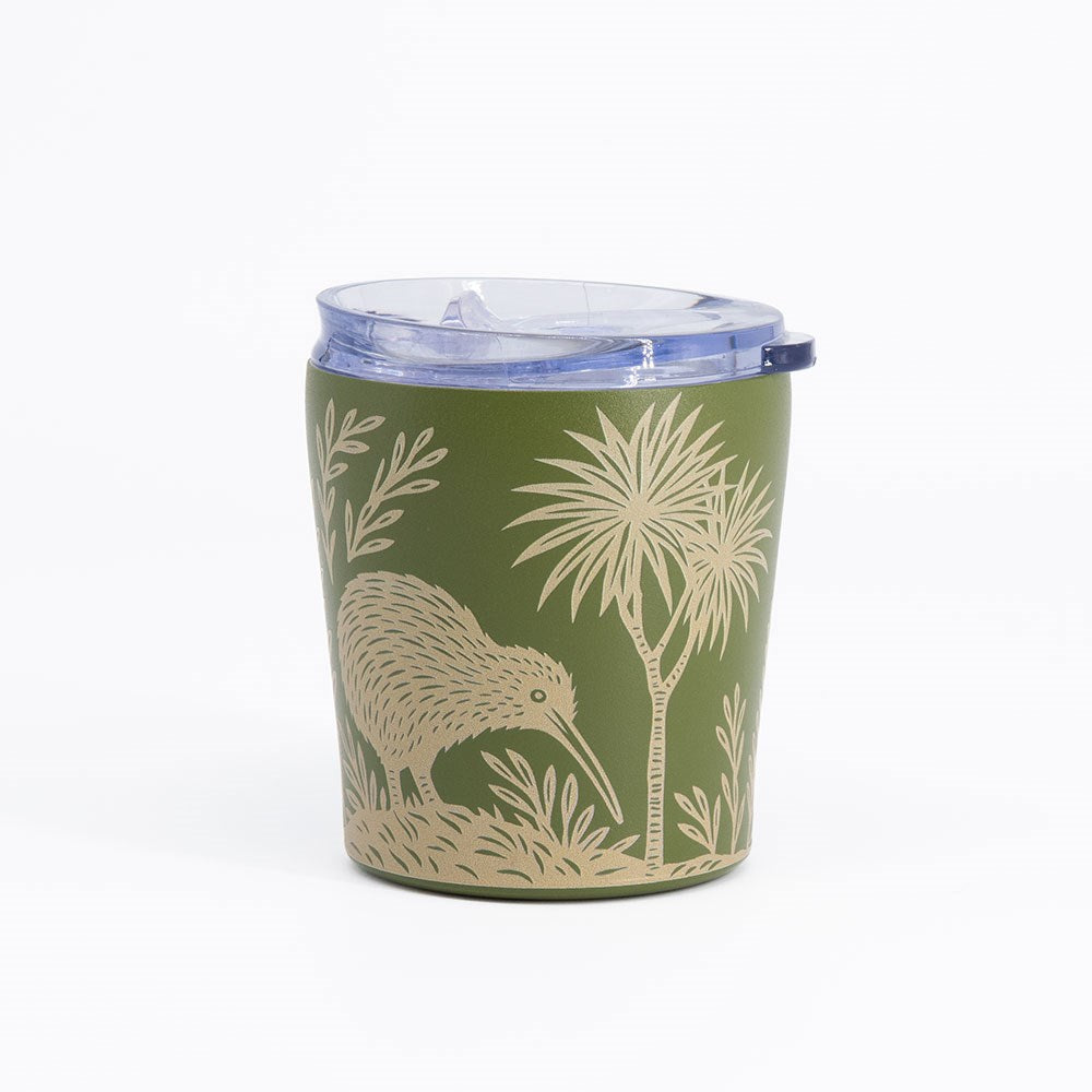 The Woodcut Kiwi Coffee Cup is a green reusable travel mug with a clear plastic lid, adorned with a beige woodcut-style illustration of a kiwi bird and plants. This spill-resistant, stainless steel cup is displayed against a plain white background.
