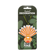 A vibrant orange and white fan-shaped Fantail Wooden Decoration is attached to a green ribbon, displayed on leafy-themed packaging with "100% NZ" at the bottom.