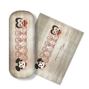 The Dick Frizzell - Mickey To Tiki Glasses Case comes with a high-quality microfibre cloth, both featuring overlapping Mickey Mouse line drawings and MICKEY TO THE POWER on a beige background. Ideal for cleaning glasses and screens.