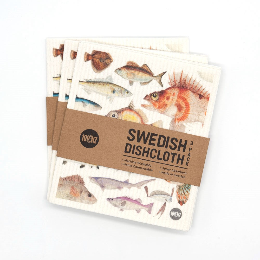 Three eco-friendly Swedish Dishcloths - Fishes of NZ with vibrant fish designs are stacked and wrapped in a brown label reading Swedish Dishcloth 3 Pack with product details, set against a white background.