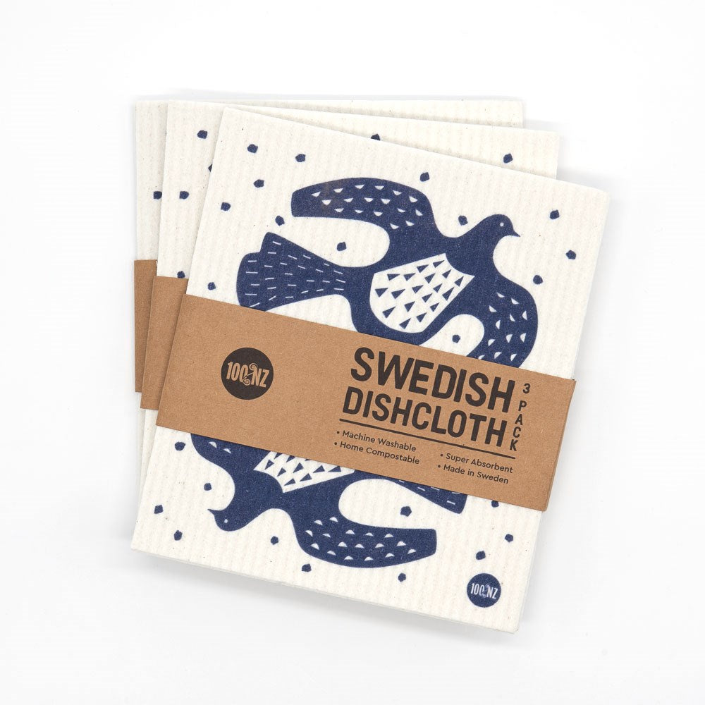 A 3-pack of eco-friendly Swedish Dishcloths - Linocut, featuring a blue bird and dot design. Wrapped in a brown paper label reading Swedish Dishcloth 3 Pack. Washable, compostable, and made in Sweden.