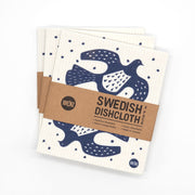 A 3-pack of eco-friendly Swedish Dishcloths - Linocut, featuring a blue bird and dot design. Wrapped in a brown paper label reading Swedish Dishcloth 3 Pack. Washable, compostable, and made in Sweden.