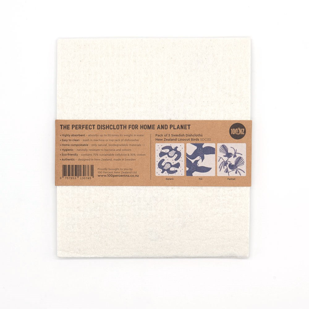 A pack of two eco-friendly white Swedish Dishcloths - Linocut, wrapped in a brown paper label with text and three small Kiwiana linocut illustrations: korimako, tui, and fantail.