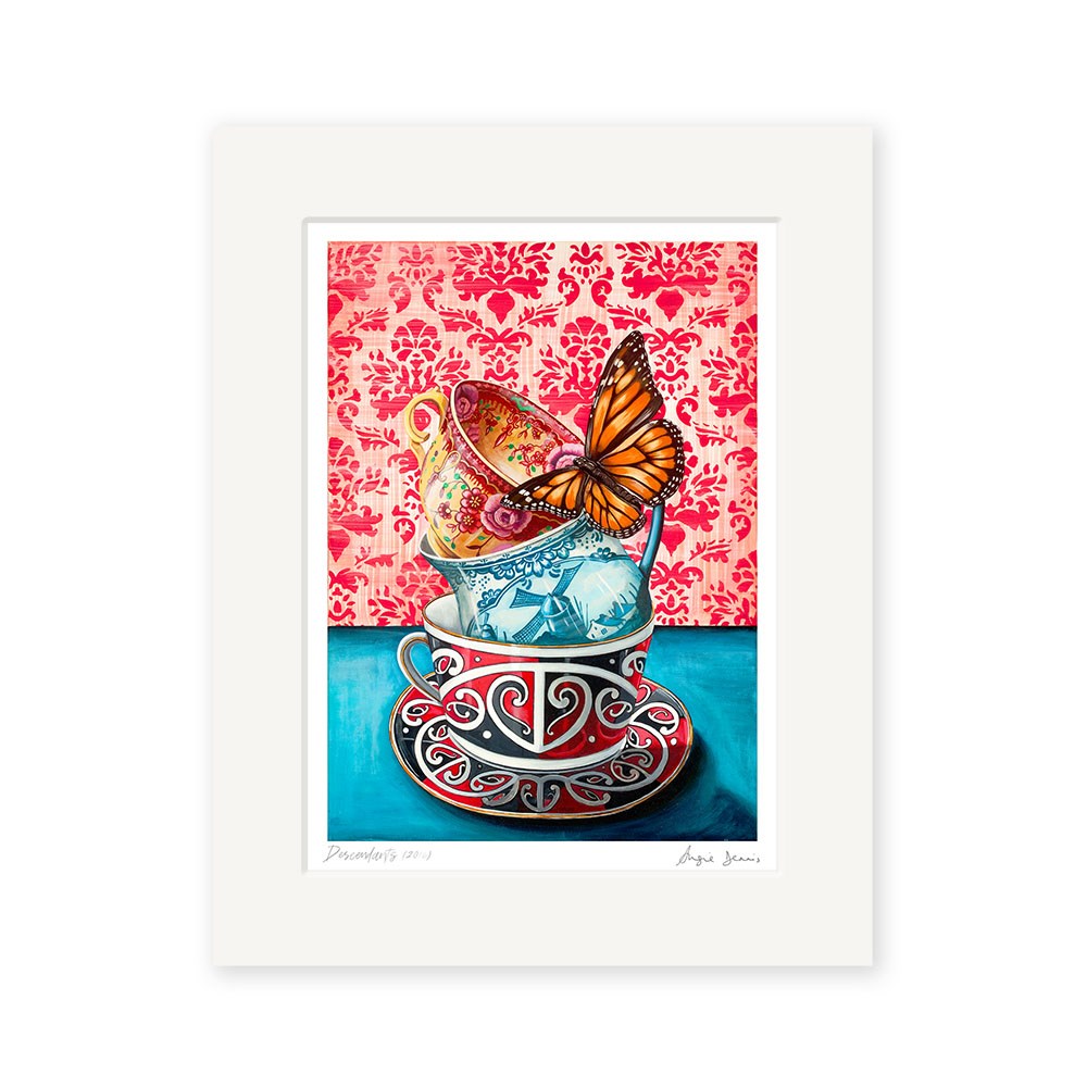 The Angie Dennis - Descendants Art Print is a framed archival-quality New Zealand artwork showing three ornate teacups stacked on a blue surface, a monarch butterfly on the yellow cup, and a pink damask background.