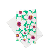 The Bright Botanical Manuka Gift Card & Envelope (6 Pack) features a vibrant floral pattern with large Manuka flowers on green—perfect for gifting and inspired by New Zealand’s beauty. Includes six cards and plain white envelopes.