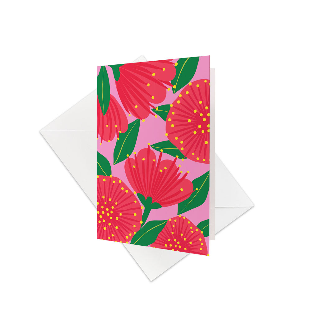 The Bright Botanical Pink Pohutukawa Gift Card & Envelope (6 Pack) features bold red Pohutukawa flowers with yellow dots and green leaves on a pink background—ideal for gift cards or celebrating New Zealand’s natural beauty.