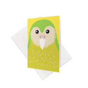 The Bright Kakapo Gift Card & Envelope (6 Pack) features a stylized Kakapo on a yellow background, propped before a white envelope on a clean surface—ideal for unique New Zealand-themed greetings or gifts.