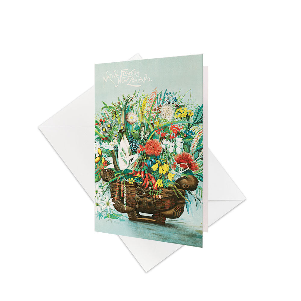 The NZ Native Flowers Gift Card & Envelope (6 Pack) features colorful native flora in a carved wooden container, with “Native Flowers of New Zealand” at the top. Includes white envelopes. Blank inside—ideal for gift cards or personal messages.