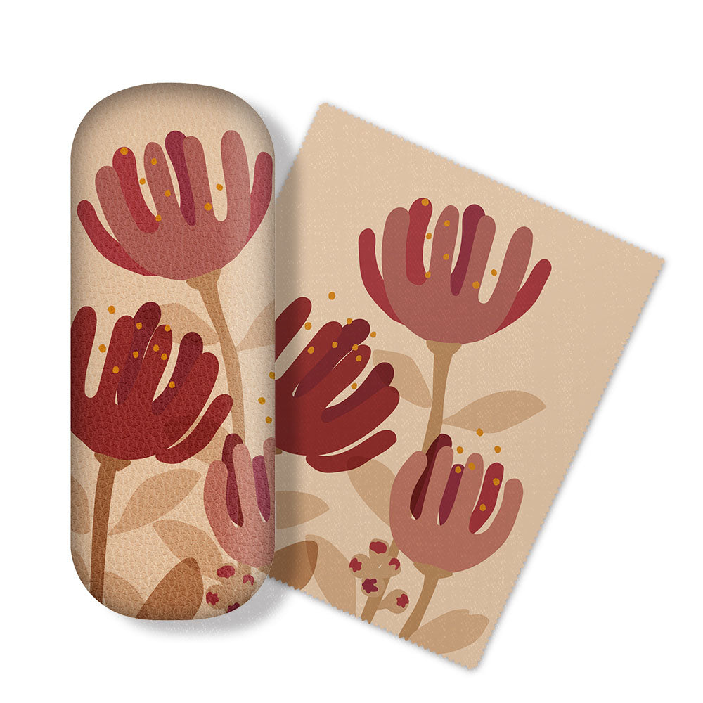 The Raw Pohutukawa Glasses Case features a beige oval micro-fibre cloth with a red and pink floral New Zealand design, paired with a matching square card—ideal for cleaning electronics.
