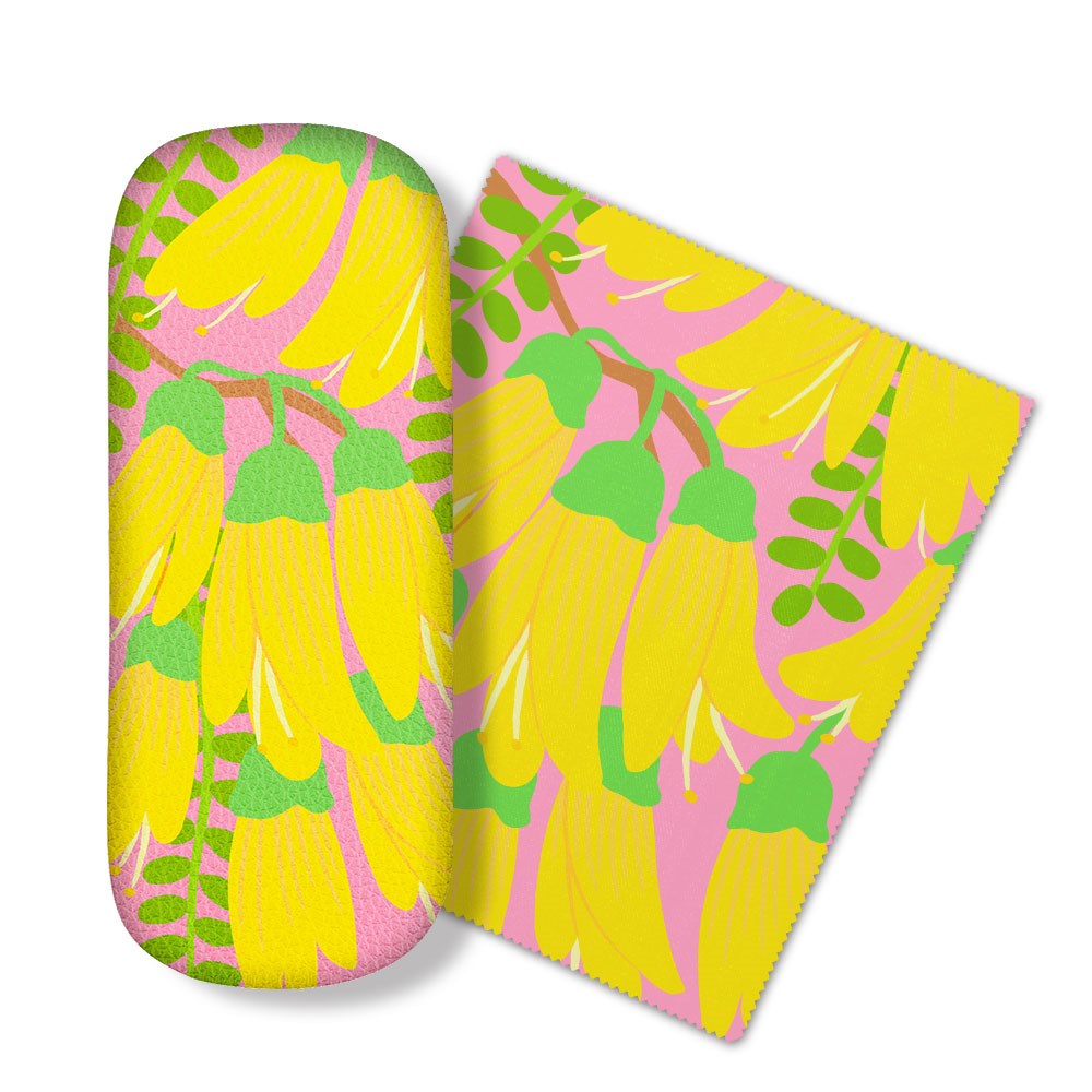 The Bright Botanical Kowhai Glasses Case, with a yellow flower and green stem pattern on pink, comes with a matching microfibre cloth. Both are ideal for cleaning glasses or screens and are shown side by side on a white surface.