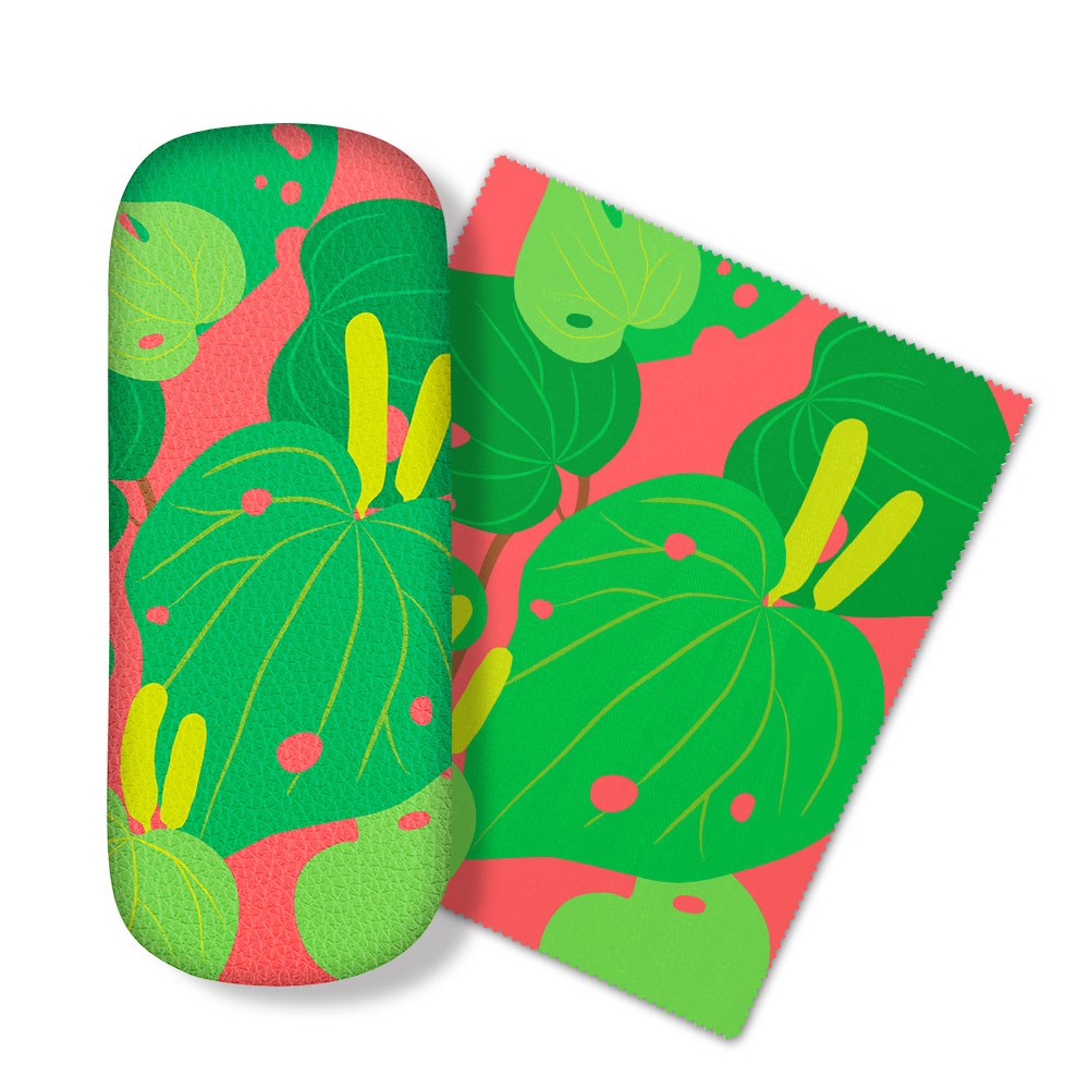 The Bright Botanical Kawakawa Glasses Case comes with a matching microfibre cloth, both decorated with large green leaves and yellow accents on a pink background—perfect for cleaning glasses and screens.
