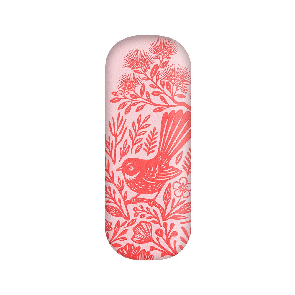 The Woodcut Fantail Glasses Case is a metal, hard-shell glasses case with rounded edges, crafted from vegan leather and featuring a red illustration of a fantail bird surrounded by flowers and foliage on a pale pink background.