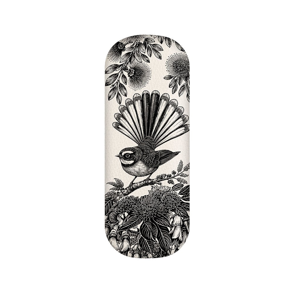 The In Bloom Glasses Case features a black and white illustration of a bird with a fanned tail perched on a branch amidst intricate leaves and flowers, all framed by an oval-shaped background. Crafted from vegan leather, this elegant hard shell case provides stylish protection for your eyewear.