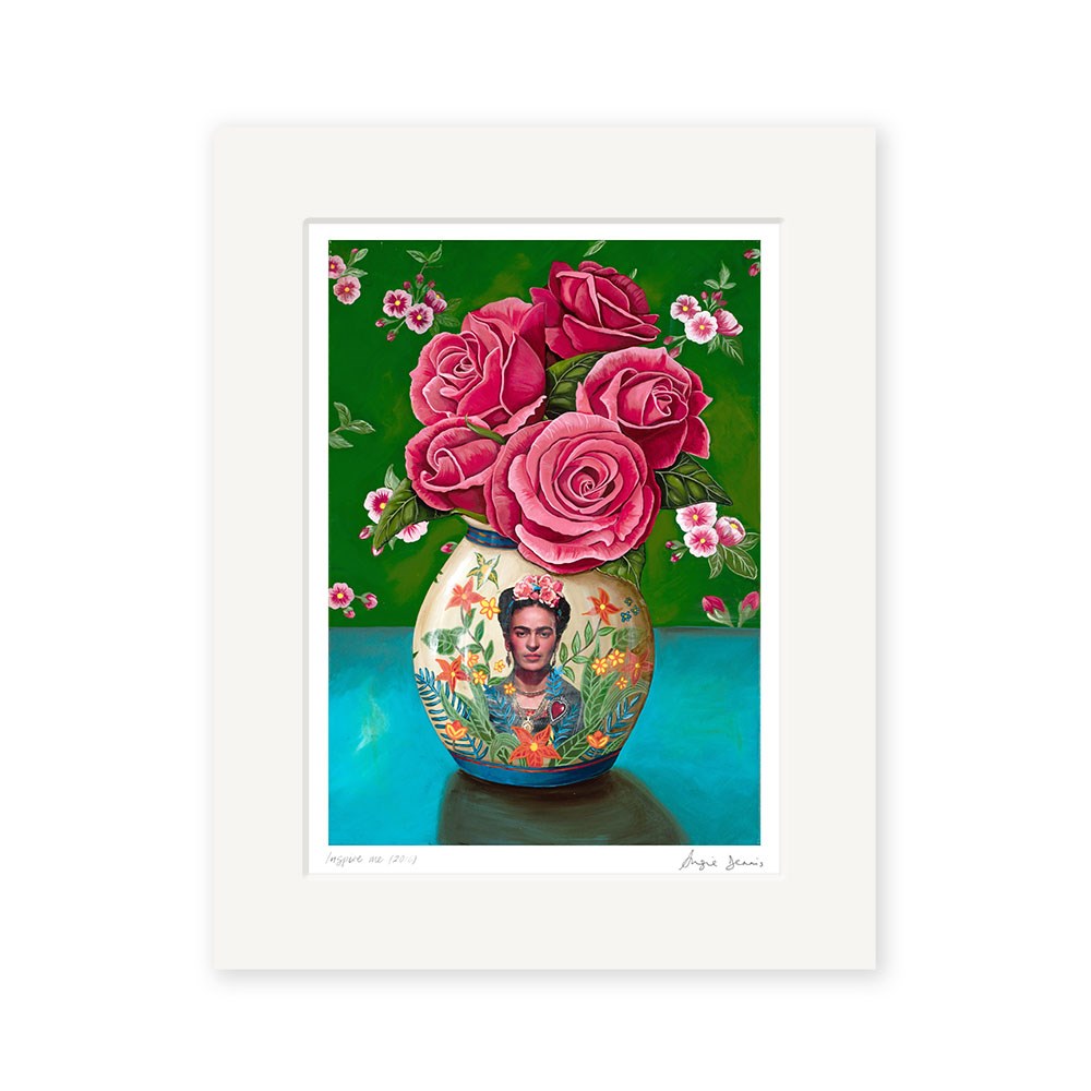 The Angie Dennis - Inspire Me Art Print features a vase with a Frida Kahlo portrait and florals, holding pink roses on a blue surface with a green background. This New Zealand art print has an archival quality matte paper border.